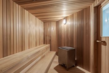 a sauna with wooden walls and a wooden floor and a suitcase at The Citizen at Shirlington Village in Arlington, Virginia 22206